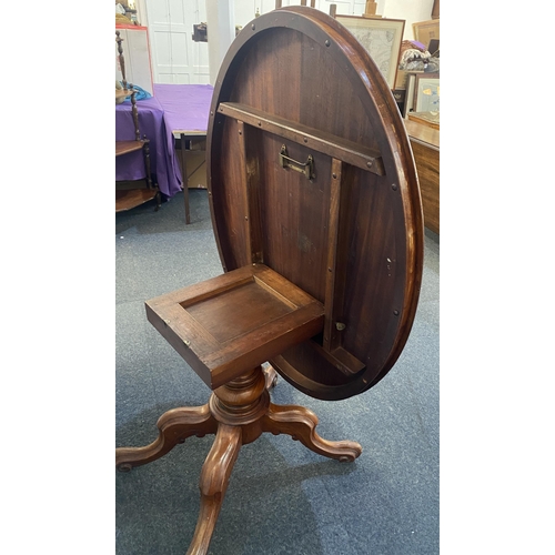 881 - A Victorian mahogany oval loo table, the hinged top with moulded edges raised on a solid baluster tu... 