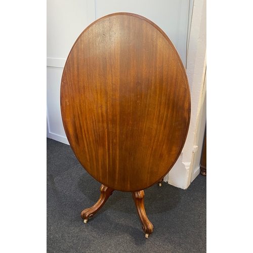 881 - A Victorian mahogany oval loo table, the hinged top with moulded edges raised on a solid baluster tu... 