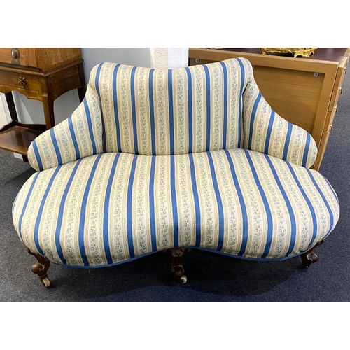902 - A small Victorian corner fitting sofa, re-upholstered in a Regency style fabric, raised on three fro... 