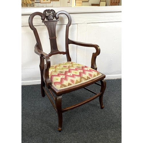 908 - An Edwardian mahogany open armchair, having a decorative carved and pierced back above the re uphols... 