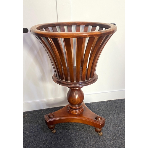 913 - A George III style mahogany plant stand, having a flared tapered circular top section raised on a tu... 