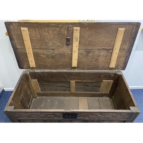914 - An 18th century and later oak coffer with carved three panel front height 69cm, width 147cm, depth 6... 