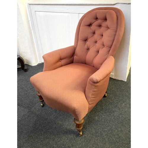 916 - A Victorian button back armchair on turned fluted legs and castors