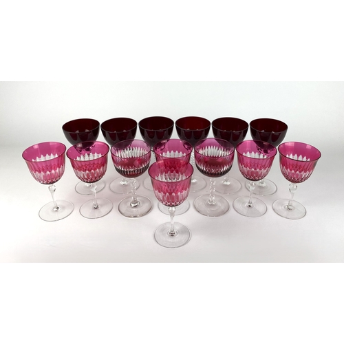 41 - A set of six cranberry cut glass wine glasses, with clear glass stems, together with a pair of cranb... 