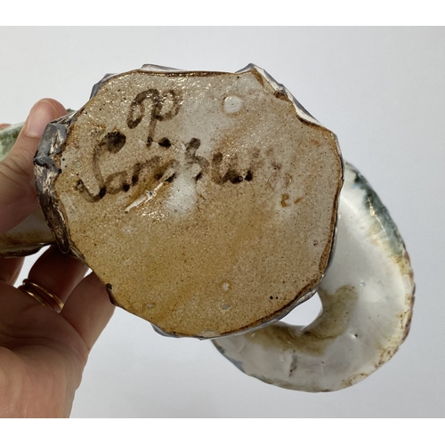 8 - A studio pottery model of a fish in brown and white glaze, inscribed 'P Sarisbury' to base 19cm long... 