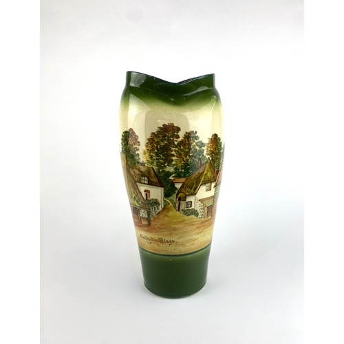 13 - A Torquay pottery vase decorated with a scenic view of Cockington Village 36cm high... 