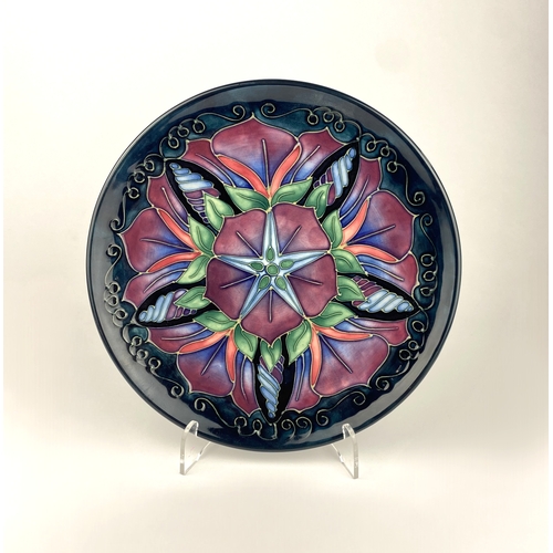 16 - A Moorcroft pottery 'Morning Glory' pattern limited edition plate, numbered 475/500, 21.5cm diameter... 