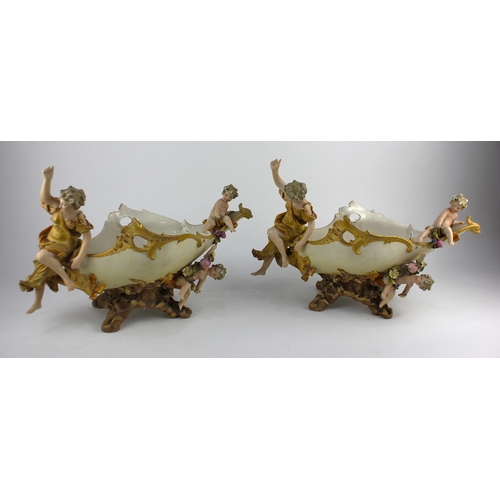 18 - A pair of Ernst Wahliss style porcelain figural table centrepieces decorated with classical figures ... 