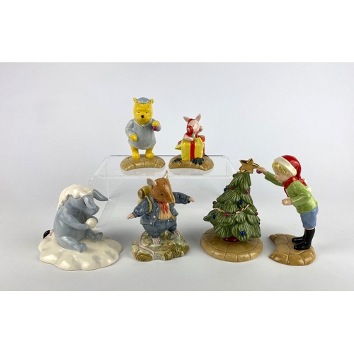 33 - Five Royal Doulton Winnie the Pooh Christmas themed figures to include 'A little tree trimming is in... 