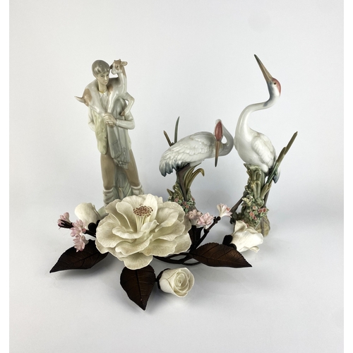 48 - A pair of Lladro porcelain models of preening cranes tallest 29cm high, and a Lladro figure of a you... 