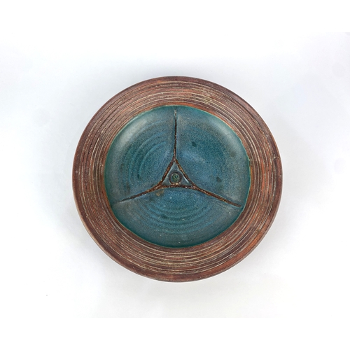 5 - A studio pottery dish, late 20th century, stoneware, with brown and teal coloured glaze, raised geom... 