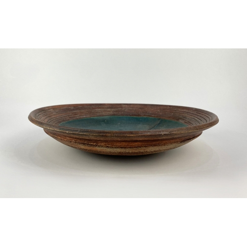 5 - A studio pottery dish, late 20th century, stoneware, with brown and teal coloured glaze, raised geom... 