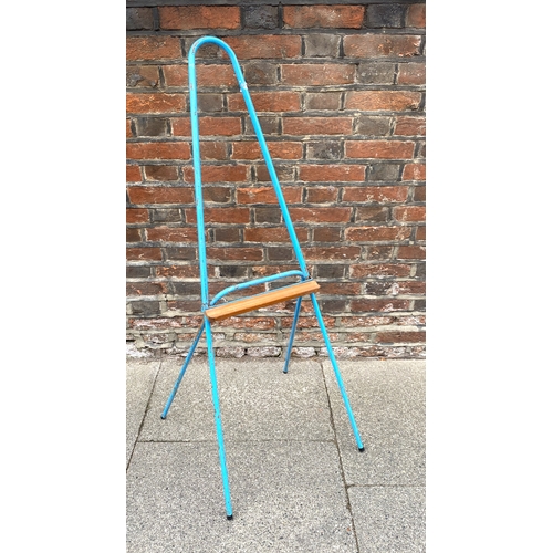 56 - A vintage child's easel, c. 1960s, of painted tubular form with wooden rest, width approximately 45c... 