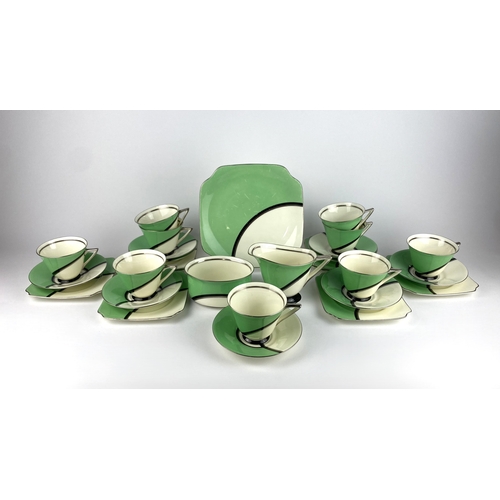 9 - An Art Deco Royal Doulton 'De Luxe' pattern part tea service in white and green, with silver and bla... 