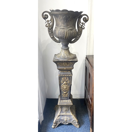 174 - An ornate cast bronzed metal twin handled urn / jardiniere, on pedestal stand, decorated throughout ... 