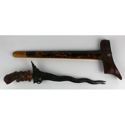 180 - A Balinese kris / keris with wavy edged blade, the hilt carved in the form of a Raksasa, blade 25cm ... 