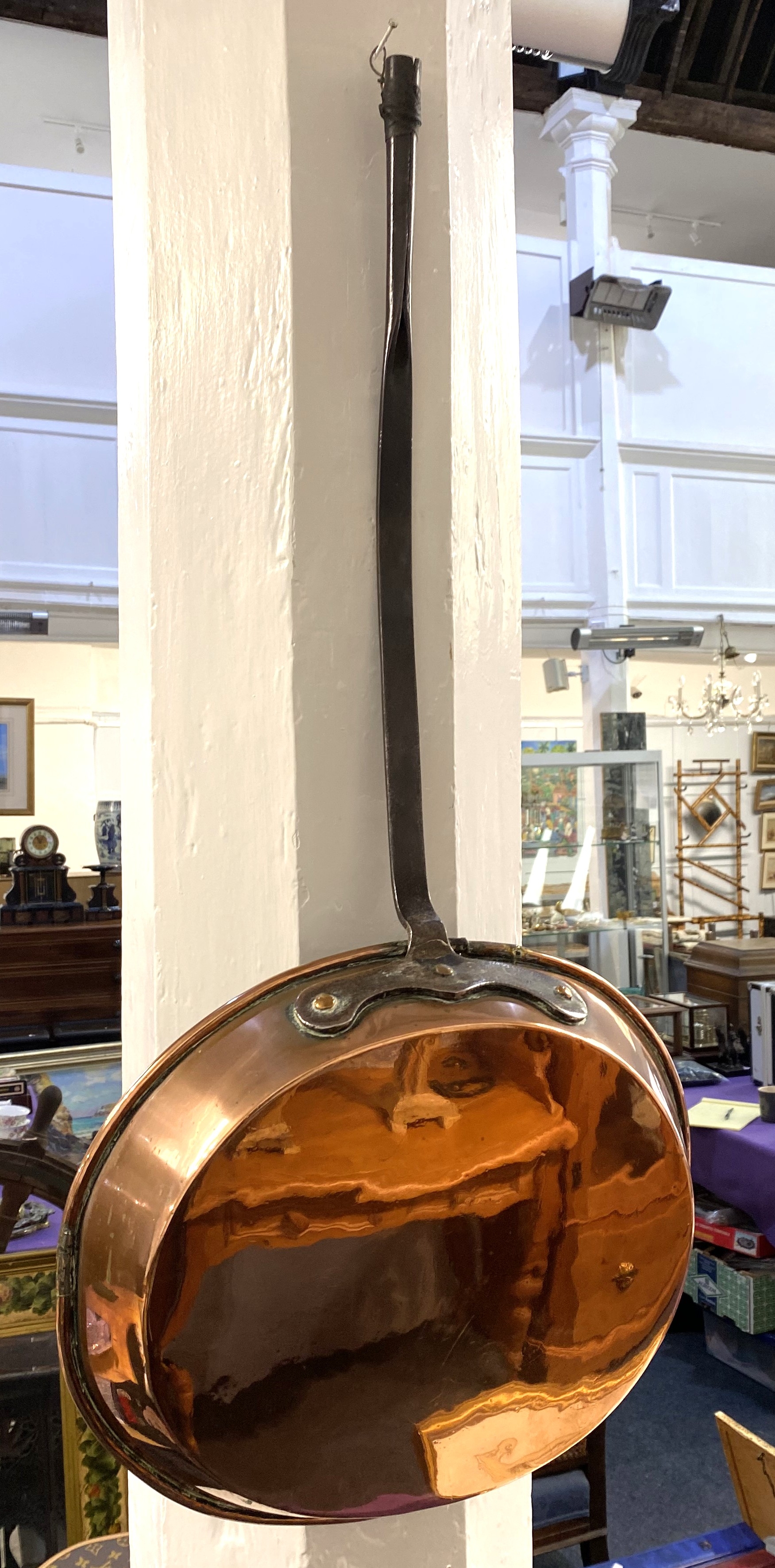 A large Victorian copper frying pan, the oval shallow pan with rolled ...
