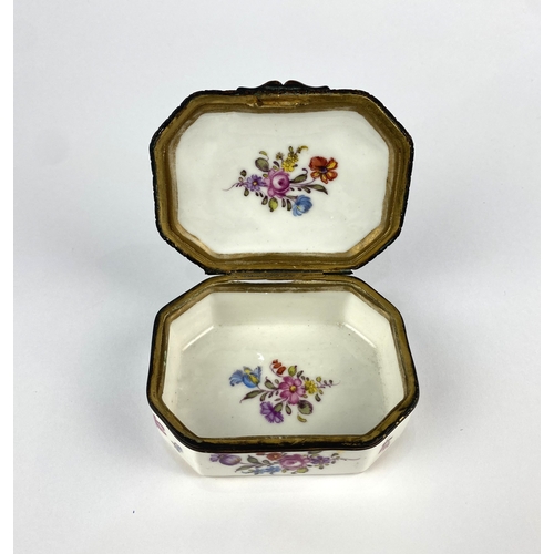 21 - A 19th century continental porcelain trinket box, of canted rectangular form, decorated against the ... 