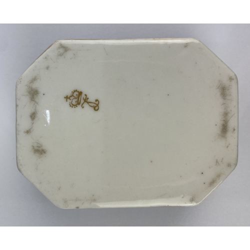 21 - A 19th century continental porcelain trinket box, of canted rectangular form, decorated against the ... 