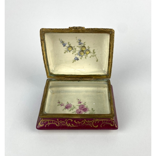 21 - A 19th century continental porcelain trinket box, of canted rectangular form, decorated against the ... 