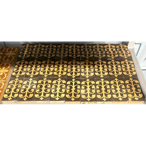 51 - Fifty-four encaustic border tiles with black and buff scrolling design, 7.7cm by 7.7cm... 