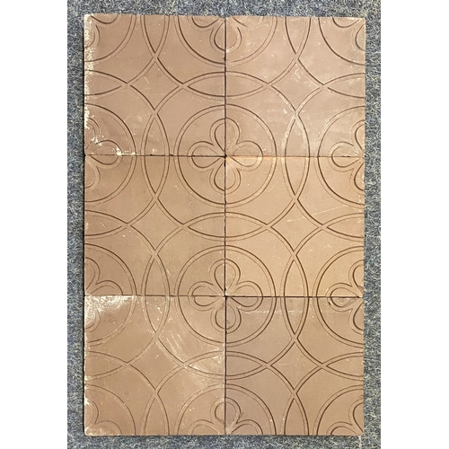 55 - Twenty-two dark red/ brown tiles inset with flower and circle design, 12.7cm by 12.7cm, and one corn... 