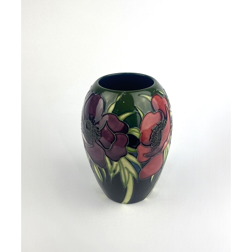 65 - A Moorcroft Pottery 'Anemone' patterned vase, 2003, by Emma Bossons, tube line decorated against the... 
