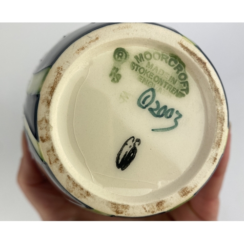65 - A Moorcroft Pottery 'Anemone' patterned vase, 2003, by Emma Bossons, tube line decorated against the... 