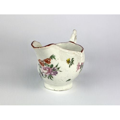 490 - An 18th century porcelain cream boat, probably Bristol, polychrome painted with floral sprays, red p... 