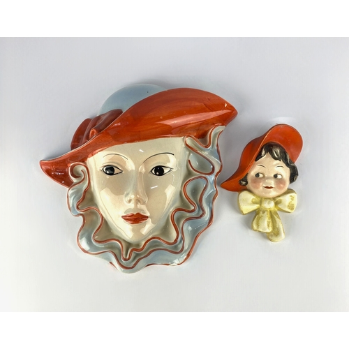 492 - A Crown Devon wall mask, hand painted by Dorothy Ann, inscribed by hand and factory marks verso, 25c... 