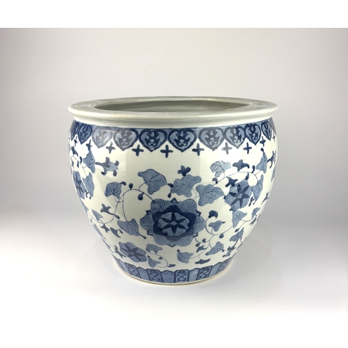121 - A modern Asian style blue and white ceramic jardiniere with foliate decoration 30cm high, 35.5cm dia... 