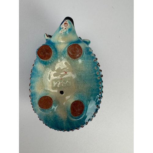 40 - An Egyptian style glazed turquoise pottery model of a hedgehog, marked '3965' to base, 10.5cm long (... 
