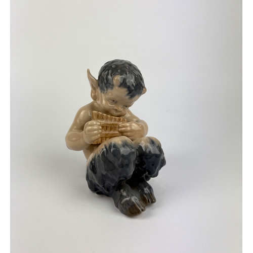 80 - A Royal Copenhagen porcelain model of a faun playing a pan flute, no 1736, 14.5cm high... 