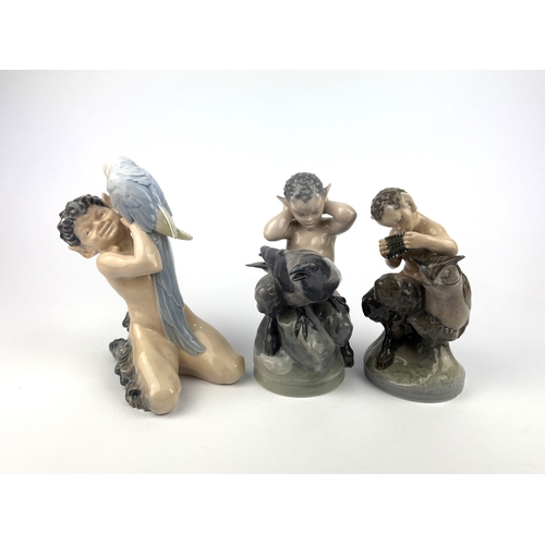 95 - Three Royal Copenhagen porcelain models of fauns with birds comprising faun with parrot 18.5cm high,... 