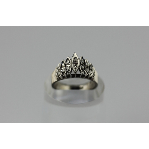 10 - A diamond ring mounted with circular cut diamonds within nine boat shaped settings, bearing stamp '1... 