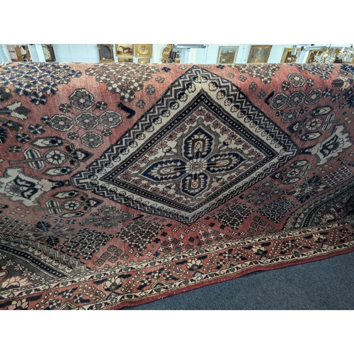 1097 - A vintage Caucasian / Afghan rug decorated with intricate geometric floral motifs on a warm teracott... 