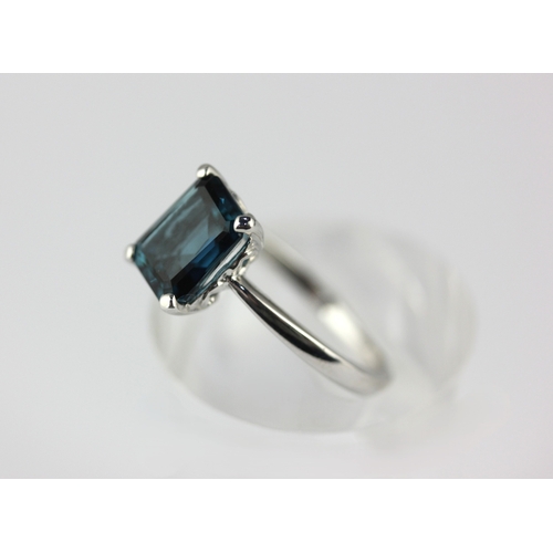 12 - A 9ct white gold ring claw set with a cut cornered rectangular step cut, London blue topaz, rign siz... 