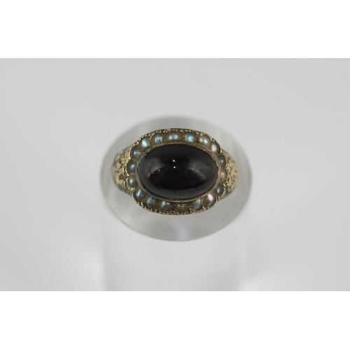 125 - A Victorian carbuncle garnet and seed pearl oval ring size M and a half, unmarked, loaded with trace... 