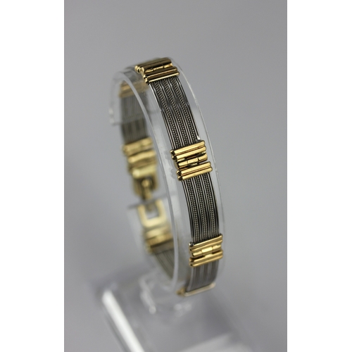 126 - A 9ct two coloured gold bracelet in a curved panel shaped link design, having a sprung clasp, length... 