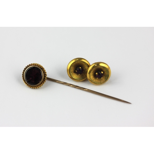 131 - A garnet single stone stick pin, unmarked, and a pair of gilt metal earrings with a case... 