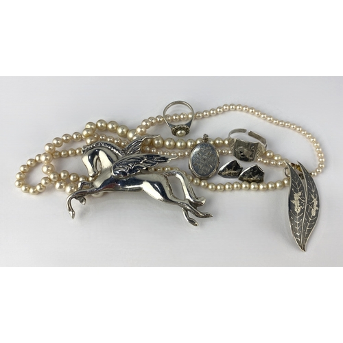 134 - A silver Pegasus brooch detailed 'silver', a silver marcasite and imitation pearl ring, a silver ova... 