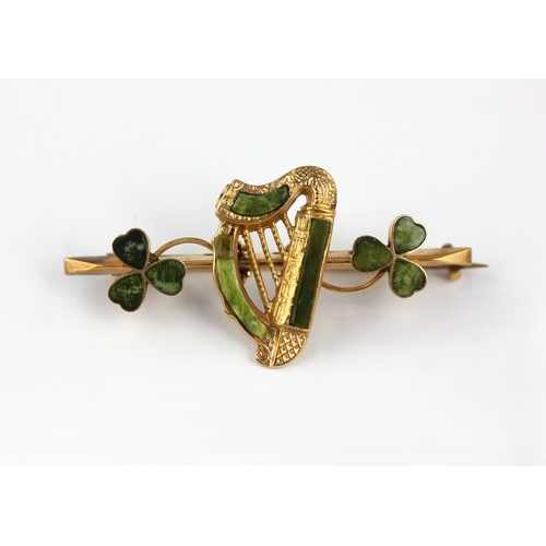 135 - A 9ct gold and Connemara marble brooch having a central harp motif between two shamrocks, Birmingham... 