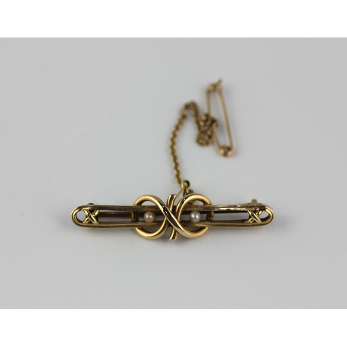 139 - A gold and seed pearl bar brooch with a woven love knot motif detailed 15ct 8, fitted with a safety ... 