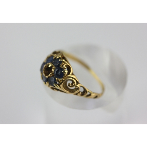 143 - A Victorian gold and sapphire ring mount (centre stone missing) with scroll pierced shoulders, unmar... 