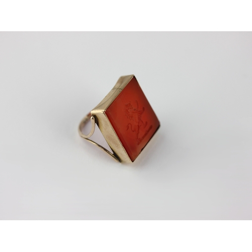 144 - A gold and cornelian intaglio ring the rectangular cornelian intaglio engraved with a lion crest, un... 