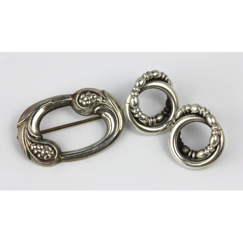 149 - A Georg Jensen silver brooch and a pair of ear studs the brooch of shaped oval open work form, detai... 