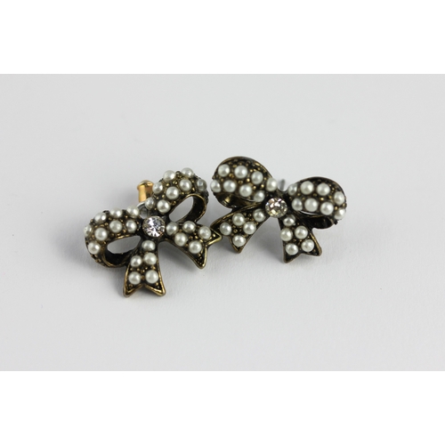 15 - A pair of imitation pearl and coloured paste bow form earrings