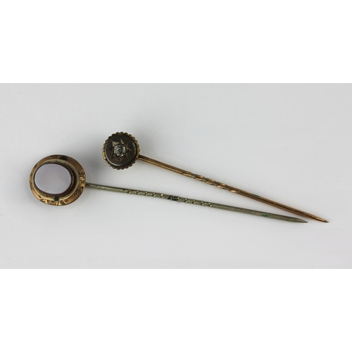 152 - Two gilt metal stick pins to include one set with sardonyx, with a case
