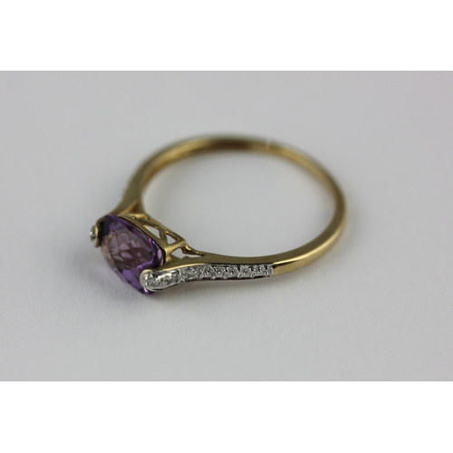 16 - A 9ct gold, amethyst and diamond ring mounted with an oval cut amethyst between diamond set shoulder... 