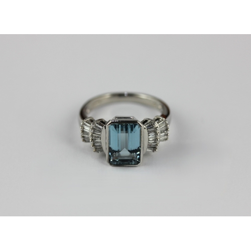 162 - An 18ct white gold, aquamarine and diamond ring collet set with the cut corned rectangular emerald c... 